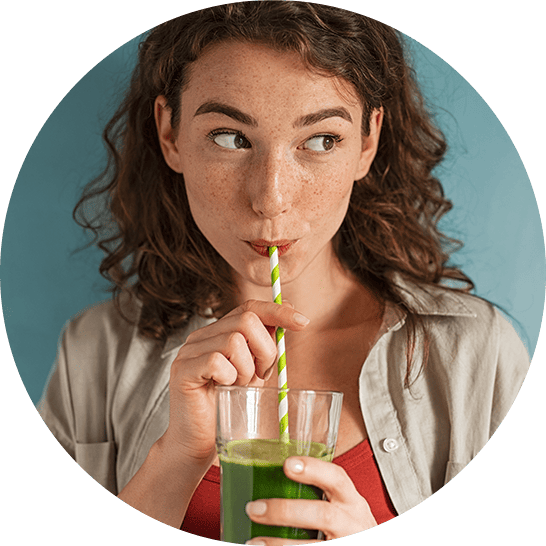 Woman sipping a green juice